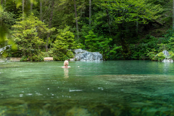 istock Woman in icy mountain water 2160584861