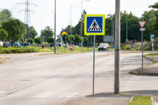 Pedestrian crossing with traffic sign in summer.