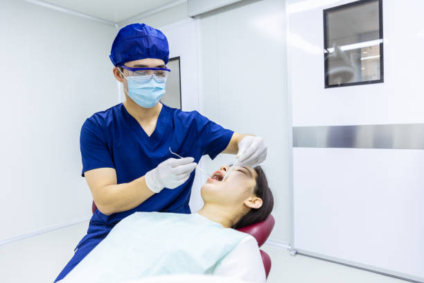 istock Dentist Examining Teeth to Female Patient 2160586049