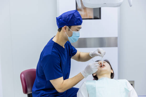 istock Dentist Examining Teeth to Female Patient 2160586068