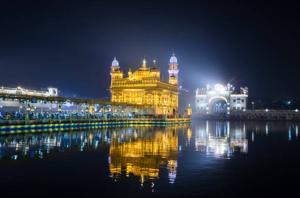 Amritsar, Punjab, India - November 05, 2019: View of Sri Harmandir Sahib, commonly known as the Golden Temple, and Amrit Sarovar during daylight.