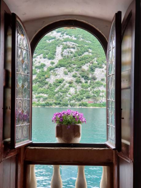 istock View out an arched window over the water 2160590017
