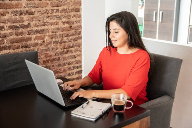 istock Young woman working using laptop at home 2160590522