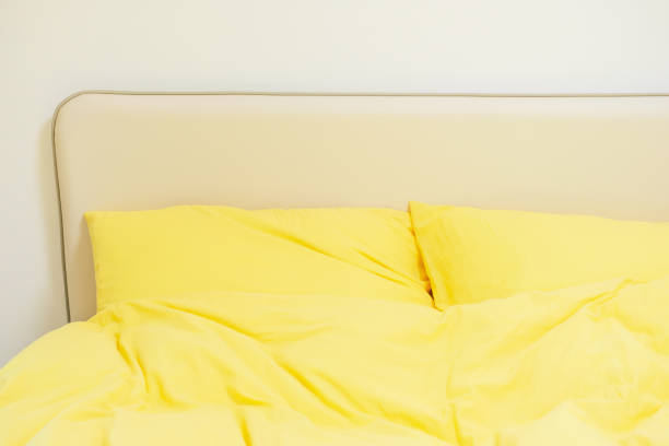 Interior of a modern bedroom in an apartment, hotel or private house with a bed and pillows