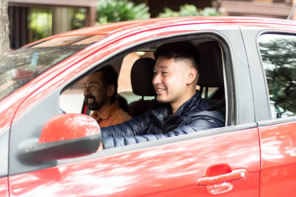 istock Young man driving the car on the road 2160591220