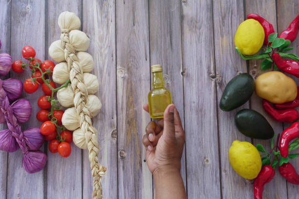hand holding a bottle of olive oil .