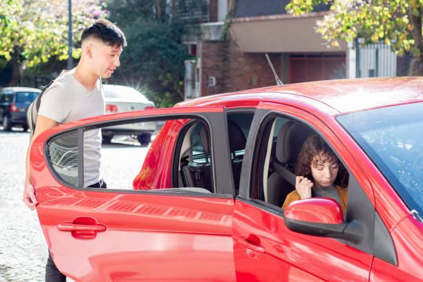 istock Young man entering on car in the city 2160591285