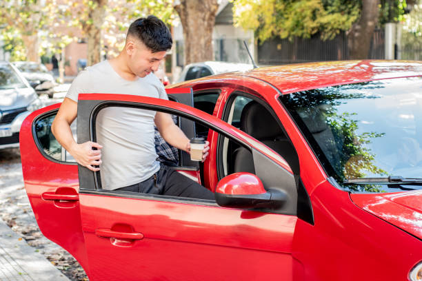 Young man entering on car in the city