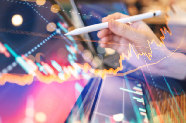 istock A business professional using a tablet AI-driven financial modeling charts displaying a smart trading interface powered AI  with detailed charts and graphs for informed trading decisions 2160593900