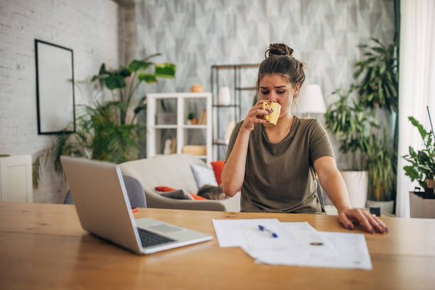 istock Woman taking a drink during work at home setup. 2160594285