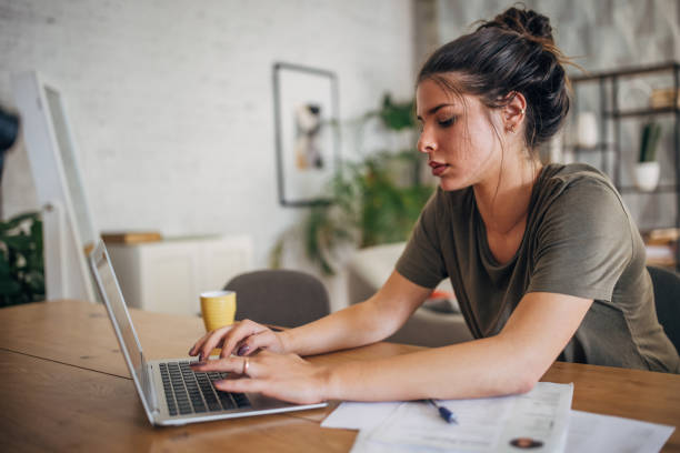 istock Woman typing on laptop at organized work desk. 2160594581