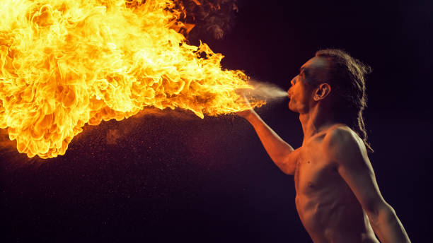 23 years old man is practicing with contact stuff. He is playing with fire so confidently