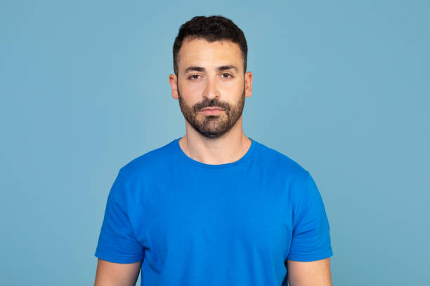 istock Portrait of handsome bearded man over blue studio background, empty space. Middle-aged bearded man posing for male magazine or blog, youth, healthy lifestyle and male cosmetology concept 2160594768