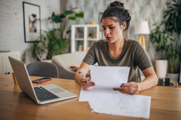istock Woman works on documents at her desk 2160595476