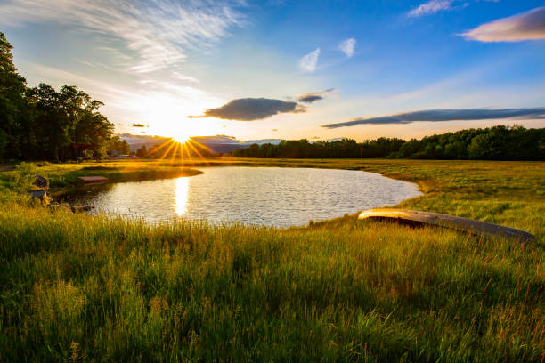 istock Scenic sunset at the lake with boat on the side 2160595628