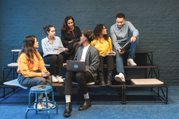 istock group of young people sharing ideas in meeting 2160595712