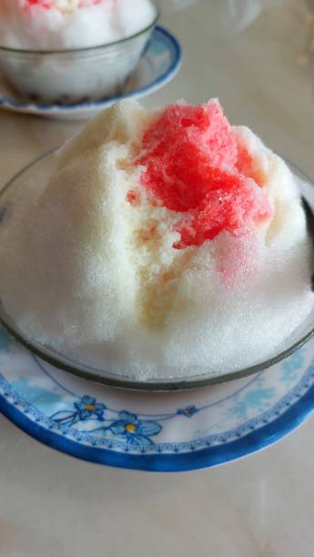 istock shaved ice with red syrup and milk topping 2160595850