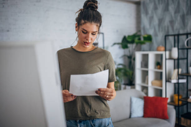 istock Young woman practicing her speech, standing in front of a mirror and holding papers 2160595865