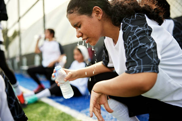 istock Young Saudi footballer cooling off with water 2160596659