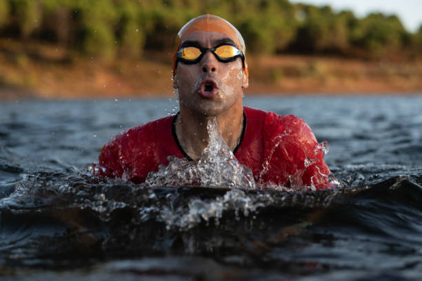 istock triathlete trains on a lake for competitions with his sunglasses and hat 2160597600