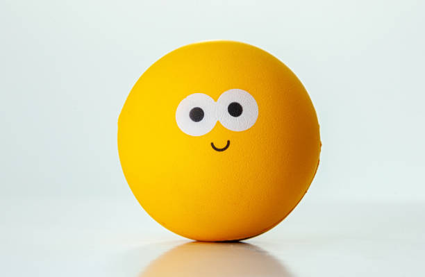 Yellow ball with a happy expression on a white background representing happiness and joy