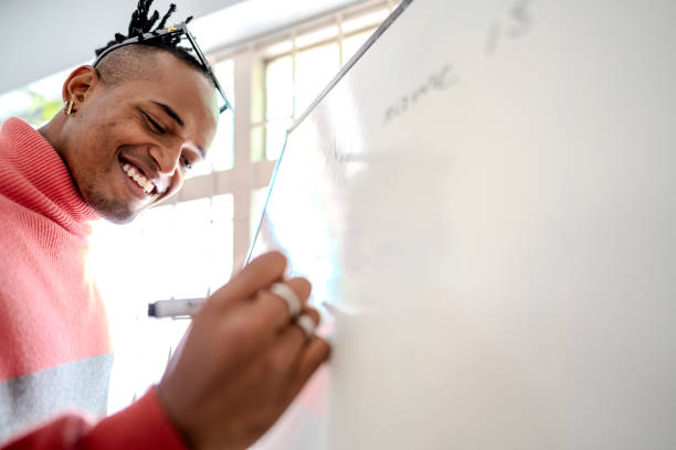 istock Young man writing on a whiteboard in the classroom 2160598739