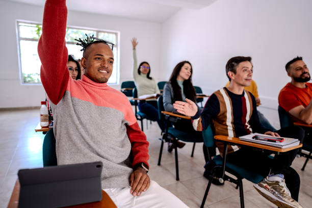 istock Young man asking questions during language class in the classroom 2160598818