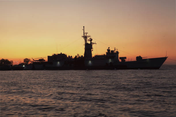 istock Silhouette of a war ship at sunset in summer. 2160601003