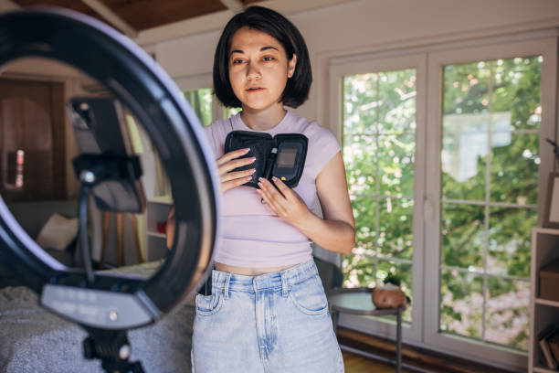 istock Lady filming vlog content with ring light and camera 2160601757