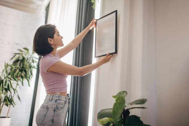 istock Modern home art placement and decoration by woman. 2160601803