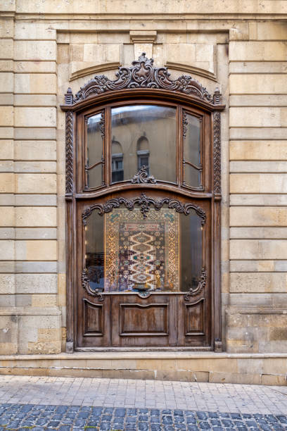 istock Storefront with an ornate wooden window, displaying a patterned rug in Old Town, aka Icherisheher, in Baku, Azerbaijan 2160602080