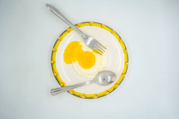 A fried poached egg with yellow poached egg on a plate ready to eat delicious
