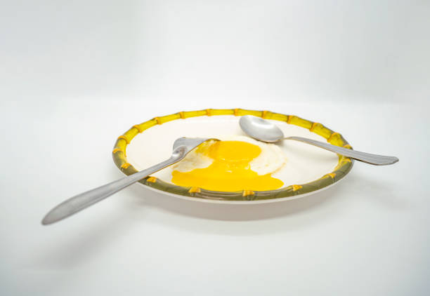 A fried poached egg with yellow poached egg on a plate ready to eat delicious