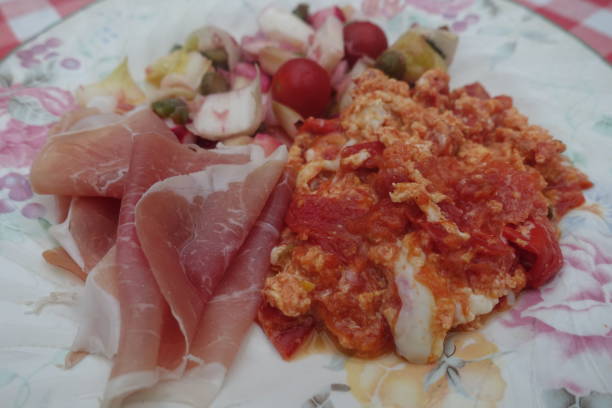 istock Scrambled eggs served with slices of raw ham and a mixed salad 2160603189