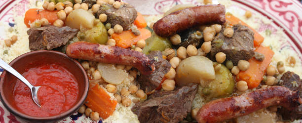 istock Royal couscous with beef merguez mixed vegetables chickpeas spicy broth served in a Middle Eastern presentation dish Harissa sauce 2160603771
