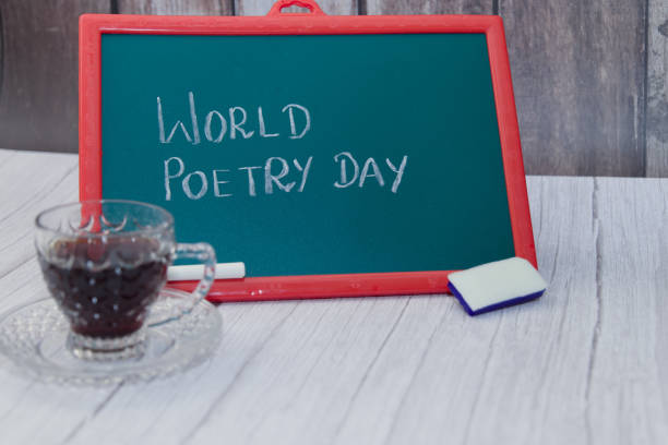 A chalkboard with the words World Poetry Day written on it