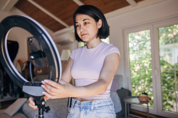 istock Woman setting up for a professional video shoot 2160607027