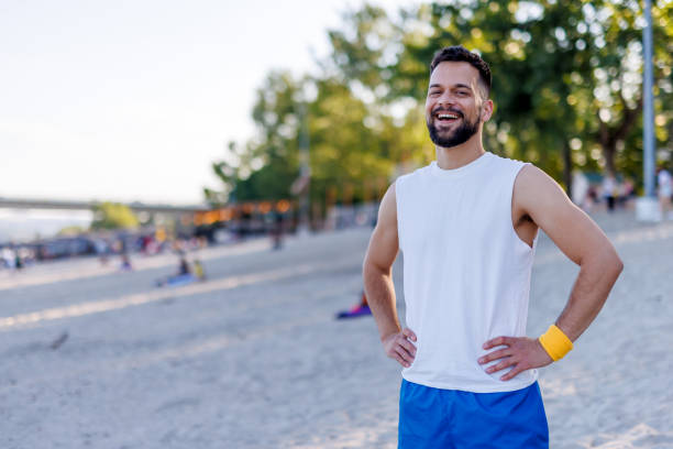 istock Cheerful man standing on the beach under clear sky 2160609213