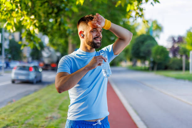 Man with water bottle enjoying an outdoor exercise break