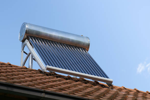 istock solar water heater on a roof top, solar water heating panel, blue sky in the background 2160610529