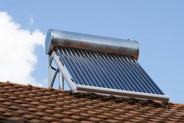 istock solar water heater on a roof top, solar water heating panel, blue sky in the background 2160610558