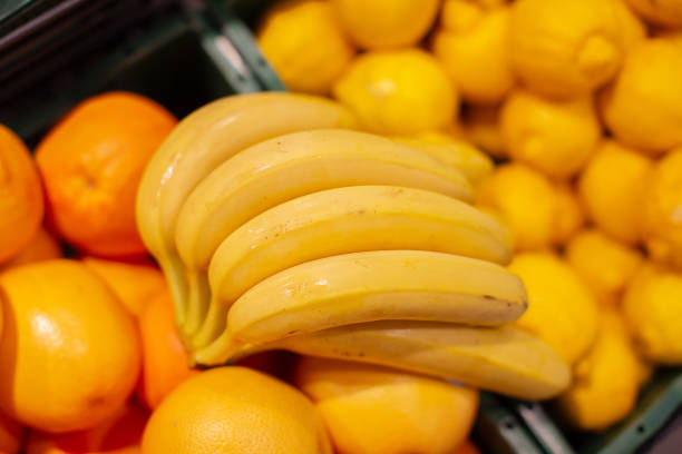 Banana branches and oranges are shot from above.