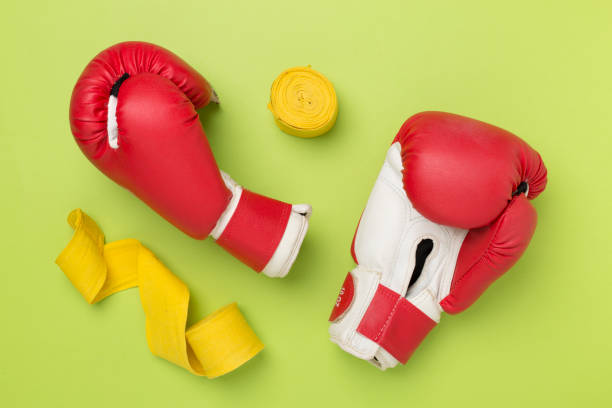 istock Red boxing gloves on color background, top view. 2160611741