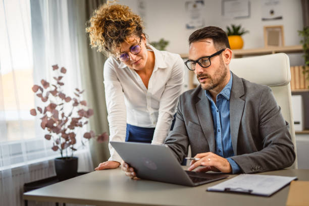 istock Two colleagues have consultation at office about work use laptop 2160613443