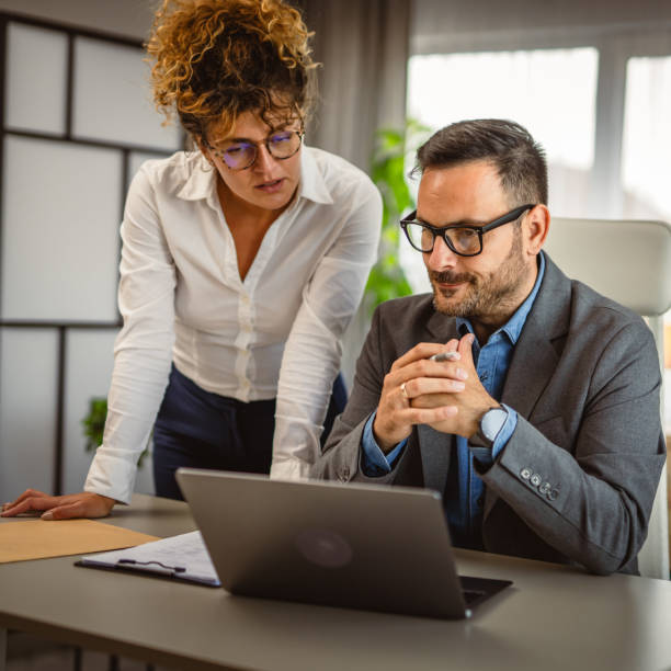istock Two colleagues have consultation at office about work use laptop 2160613504