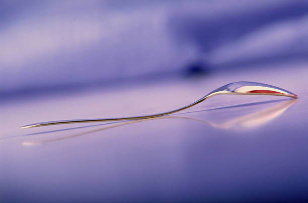 One metal teaspoon lies on the table. Cutlery. Web banner.