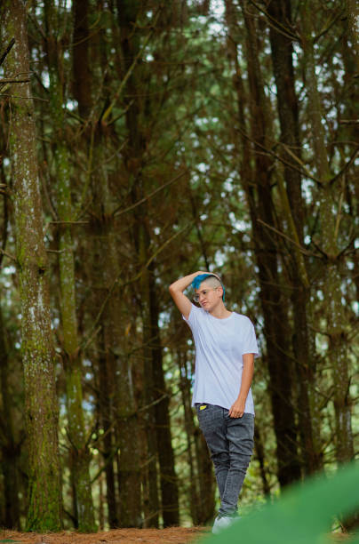 young hispanic latina woman outdoors wearing comfortable clothes with one hand on top of her head