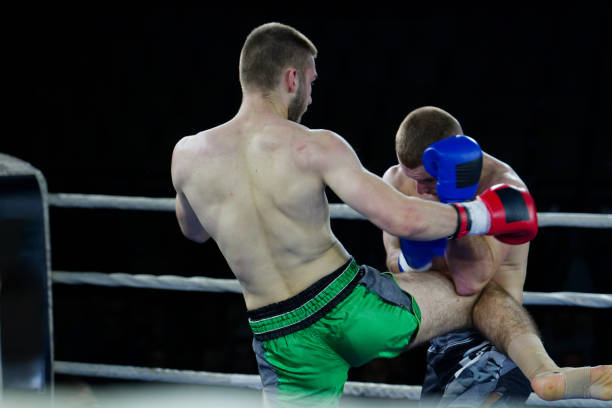istock Kickboxing rivals unleash powerful leg strikes in a thrilling match. 2160624712