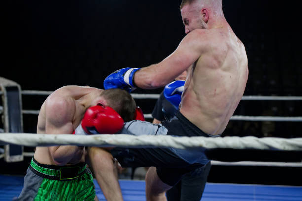 istock Kickboxing rivals unleash powerful leg strikes in a thrilling match. 2160625615