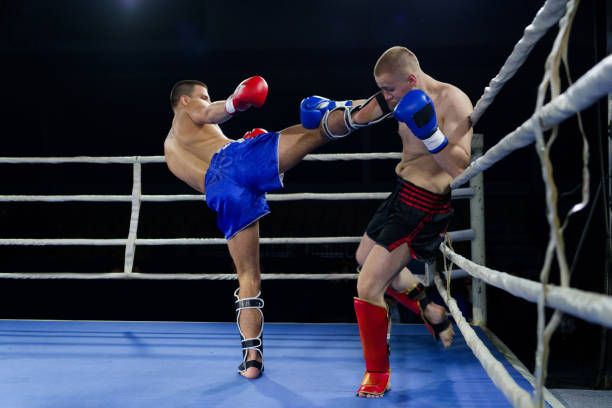 istock Kickboxing rivals unleash powerful leg strikes in a thrilling match. 2160626331